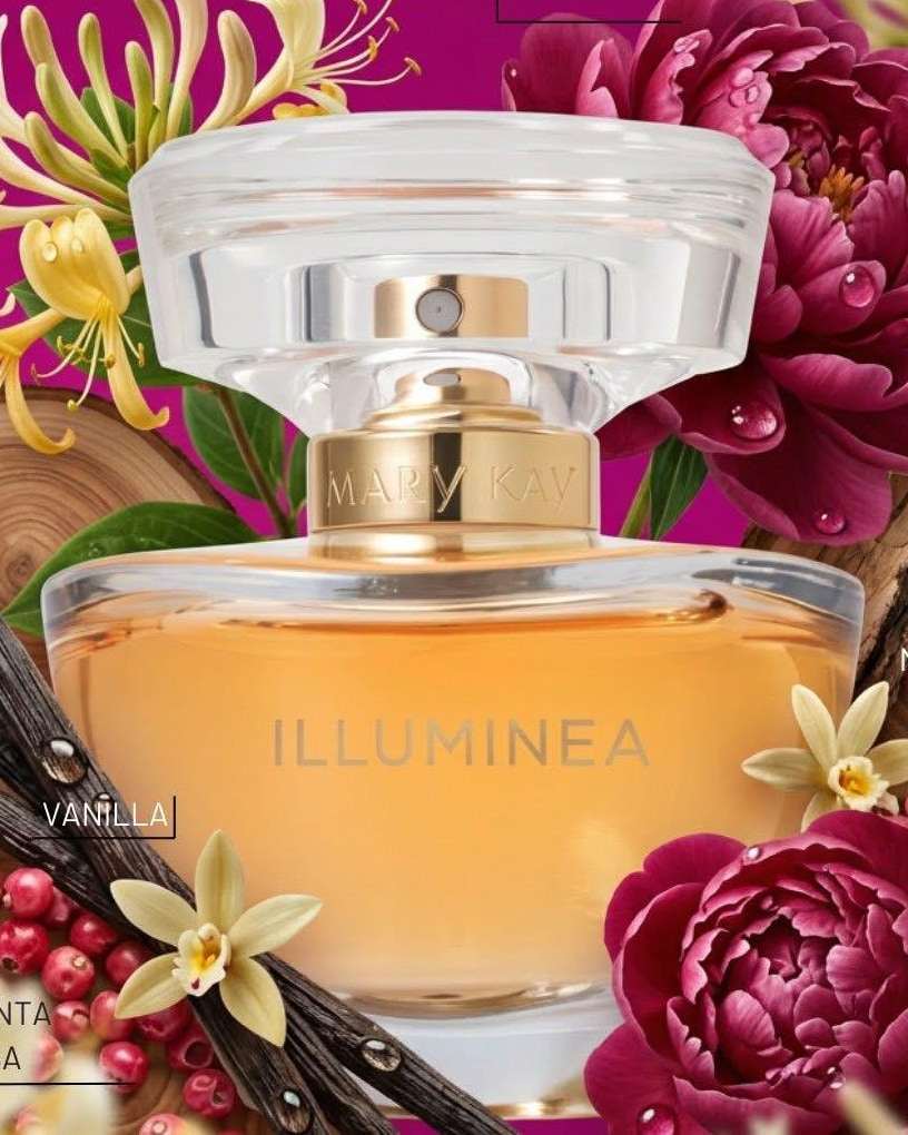 Round amber perfume bottle with a clear sculpted cap and a gold collar among peonies and honeysuckle