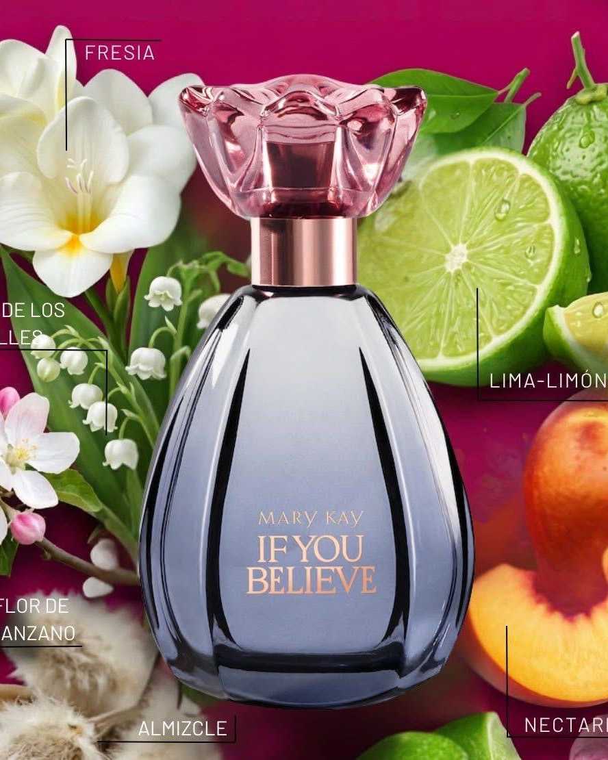 Smoky grey teardrop perfume bottle with a rose-glass flower cap among citrus and white blossoms